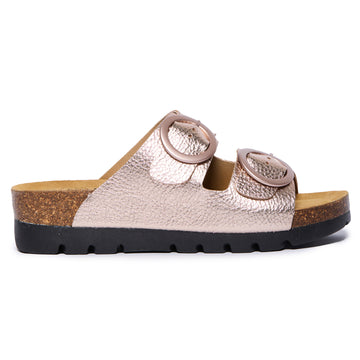Rose gold Plakton Cora sandal with two wide metallic leather straps, round oversized buckles, cork and Memory Foam footbed, and a black lightweight sole.